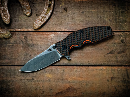 Assembly Special-Jurassic-Slicer Hollow Ground-Magnacut-Stonewash Purple-Orange/Black G10-Black Nitride Hardware/Orange Standoff-Scale Side