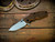 Assembly Special-Jurassic-Slicer Hollow Ground-Magnacut-Bead Blast-Orange/Black G10-Black Nitride Hardware-Scale Side