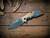 Assembly Special-Jurassic-Slicer Hollow Ground-Magnacut-Full Titanium-Satin Bronze/Blue Horsehead-Blue Titanium Hardware-Scale Side
