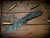 The Emmett-Magnacut-BPU1265-Black Micarta-Scale Side