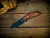 The Flashpoint-Sheespfoot-Magnacut-Battle Black-Koa-Wood Handle-Scale Side