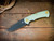 Project X-Clip Point-Magnacut-Battle Black-Special Finish-Translucent Green G10-Brass Hardware-Scale Side