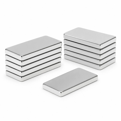 Silver rectangular block magnets arranged in two stacks with one loose magnet on a white background