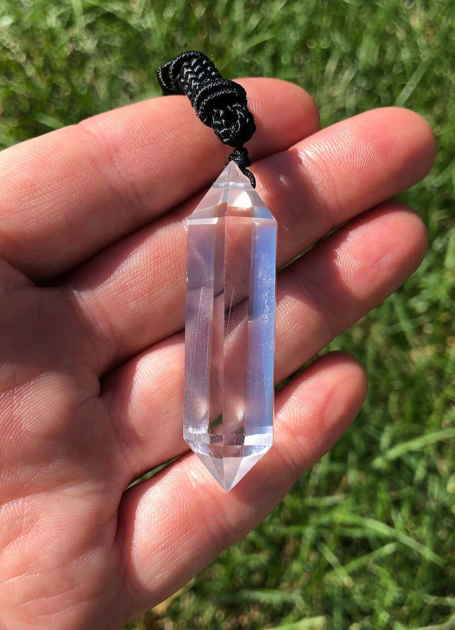 https://cdn11.bigcommerce.com/s-74zp6w28re/images/stencil/1280x1280/products/4810/39841/new-moon-beginnings-clear-quartz-pendant-with-28-adjustable-black-cord-polished-point-pendant-in-drilled-setting-jpn-vdcp117__64462.1635602319.jpg?c=1