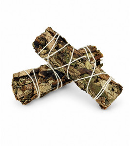 Two Yerba Santa cleansing bundles tied with white cotton string crossed on a white background
