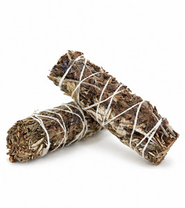 Two Yerba Santa, Lavender & Blue Sage cleansing bundles tied with white cotton string crossed on a white background