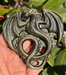 Gold Sheen Obsidian dragon carving from Mexico held in hand, a winged amphiptere coiled in relief with golden shimmer