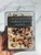 Front of Winter Spice Wax Melts package held in hand showing the crystal and botanical topping under the black label