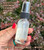 Back of the Dragon's Blood spray bottle showing crystal chips inside, with Protection, Grounding, Clearing and Shielding intentions