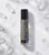 Evil Eye Protection Oil roller bottle standing upright on a white surface surrounded by clear quartz crystal chips