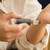 Person applying Evil Eye Protection Oil roller to their wrist