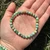 Single Variscite 6mm elastic bracelet held in an open palm outdoors