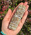 Yerba Santa, Lavender & Blue Sage cleansing bundle resting across an open palm showing the dried herbs and string wrap