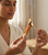 Woman lighting a Pumpkin Spice dipped Palo Santo stick with a match