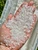 Hand holding a heaping pile of clear quartz crystal chips from a 1lb bulk bag