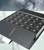 Angled view of the open crystal advent calendar lying flat on marble showing all 24 numbered drawers