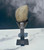 Back of the Black Amethyst cluster in its black iron stand on white marble against a misty backdrop