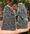 Pair of raw Black Amethyst geodes held in hand, showing natural uneven edges and agate banding