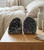 Pair of Black Amethyst geodes displayed on a wooden bedside table in a cozy bedroom