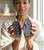 Woman holding a pair of Black Amethyst geodes, one in each hand, showing their size
