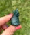 Back view of a Moss Agate sitting cat showing smooth polished green stone with darker moss inclusions