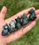Five small Moss Agate cat figurines resting in an open hand, a cute gift for cat lovers and crystal collectors
