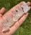 Handful of Clear Quartz sitting cat carvings with natural inclusions and frosty white tones