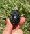 Side view of a Silver Sheen Obsidian owl showing its glossy rounded back