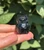 Polished Black Obsidian owl carving from Mexico held in hand, glossy black with carved eyes and feathers