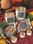 Winter Spice Candle collection in glass jars, a tin and a tealight gift box on a festive table with orange slices and cinnamon