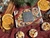 Overhead view of the Winter Spice tealight gift box with dried orange slices, cinnamon sticks, star anise and pine