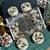 Winter Forest crystal tealight gift set in a clear box tied with silver ribbon, surrounded by loose tealights and pinecones