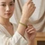 Woman in a cream top wearing a natural Peridot 4mm crystal bracelet