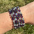 Stack of Third Eye Chakra elastic bracelets worn on wrist outdoors