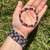 Third Eye Chakra elastic bracelet with 6mm beads held in an open palm outdoors