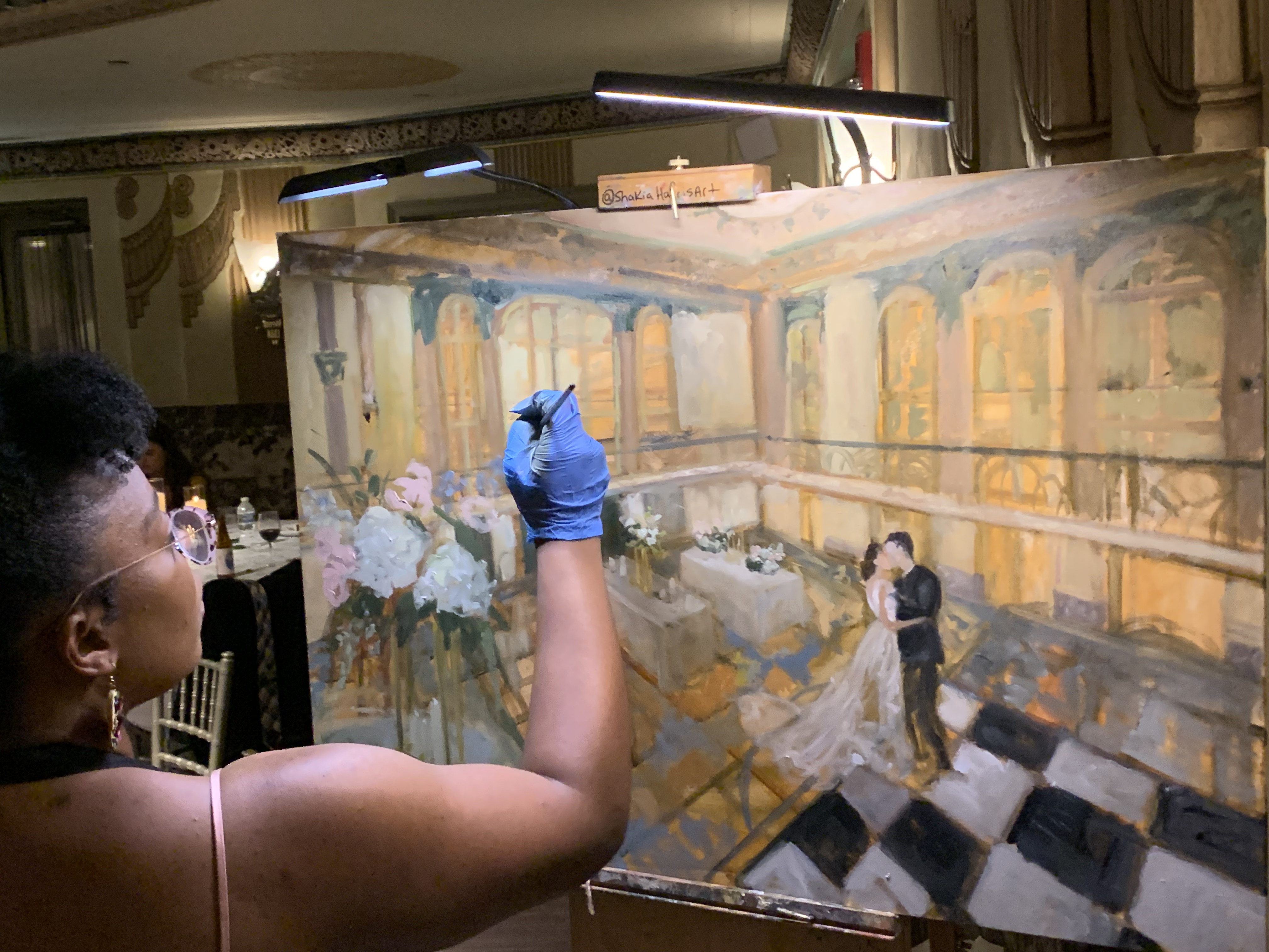 Live wedding painting is a bespoke fine art service created during your celebration and refined in the studio after the event. Couples choose this experience for its emotional impact, heirloom quality, and refined aesthetic.  As a Kentucky-based live wedding painter serving clients nationwide, I work closely with couples to create paintings that reflect their venue, atmosphere, and personal story—resulting in artwork meant to be collected, not stored away. louisville live painter kentucky live wedding artist Shakia harris paints the first dance at the pointe in butchertown downtown louisville wedding venue wedding reception