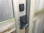 Bronze lever latch and deadbolt on cedar gate Bronze lever latch and deadbolt on cedar gate