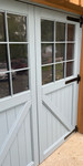 Close-up of heavy duty black strap hinges for carriage house doors Close-up of heavy duty black strap hinges for carriage house doors