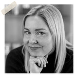 lack and white portrait of Angela Eriksen with hand resting under chin wearing dark turtleneck