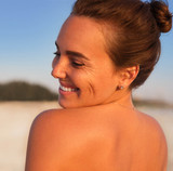 Woman smiling at the beach.