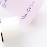 A close-up view of a pink cosmetic bottle showing partial text including "250 ml" and "8.4 fl oz" along with some product description text. A close-up view of a pink cosmetic bottle showing partial text including "250 ml" and "8.4 fl oz" along with some product description text.