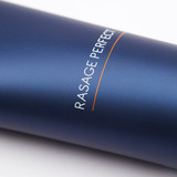 Close-up detail of "Rasage Perfect" text with orange accent line on the dark blue tube surface.