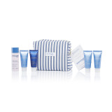 Complete Phytomer skincare travel set featuring multiple blue product tubes arranged with a blue and white striped cosmetic bag against a white background.