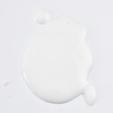 White pump dispenser cap on blue skincare bottle.