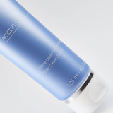 Close-up of blue skincare bottle showing "Accept Cica" and "Crème Lactée Démaquillante Milky Cream Cleanser 125 ml" labels.