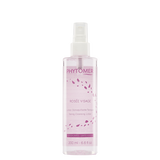 A clear glass bottle of Phytomer Rosée Visage toning cleansing lotion with pink rose petal graphics and limited edition labeling.