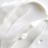 Close-up of white cream texture showing smooth, creamy consistency.