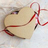 Valentines Mystery Box - a heart shaped box with ribbon strewn a crossed. 