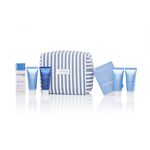 Complete Phytomer skincare travel set featuring multiple blue product tubes arranged with a blue and white striped cosmetic bag against a white background.