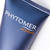 Angled view of the Phytomer Homme logo and branding on the dark blue tube with orange accent line.